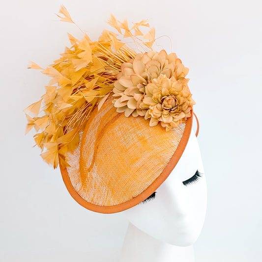 Tangerine orange flower feather disc fascinator hat