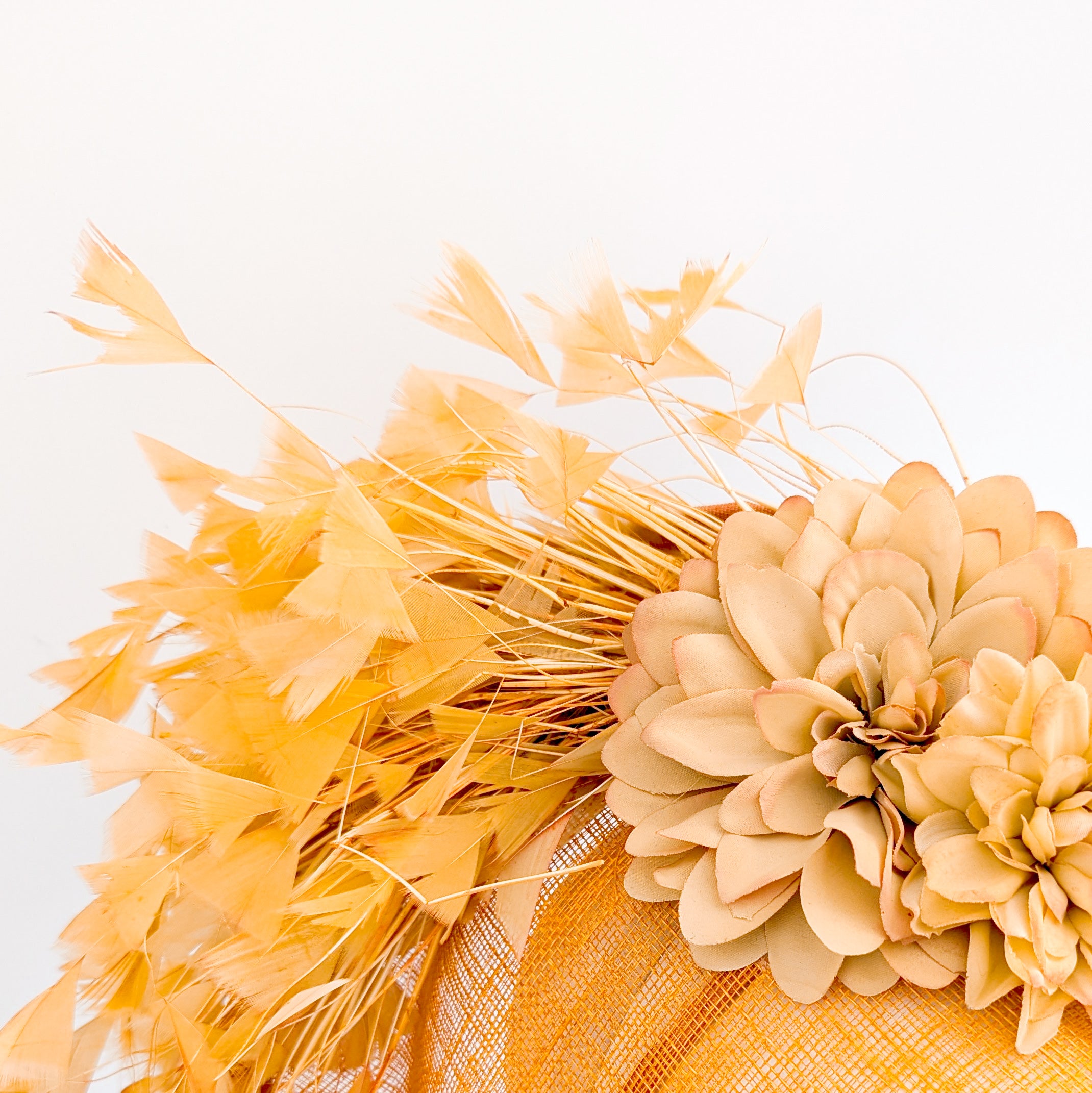 Tangerine orange flower feather disc fascinator hat