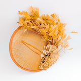 Tangerine orange flower feather disc fascinator hat