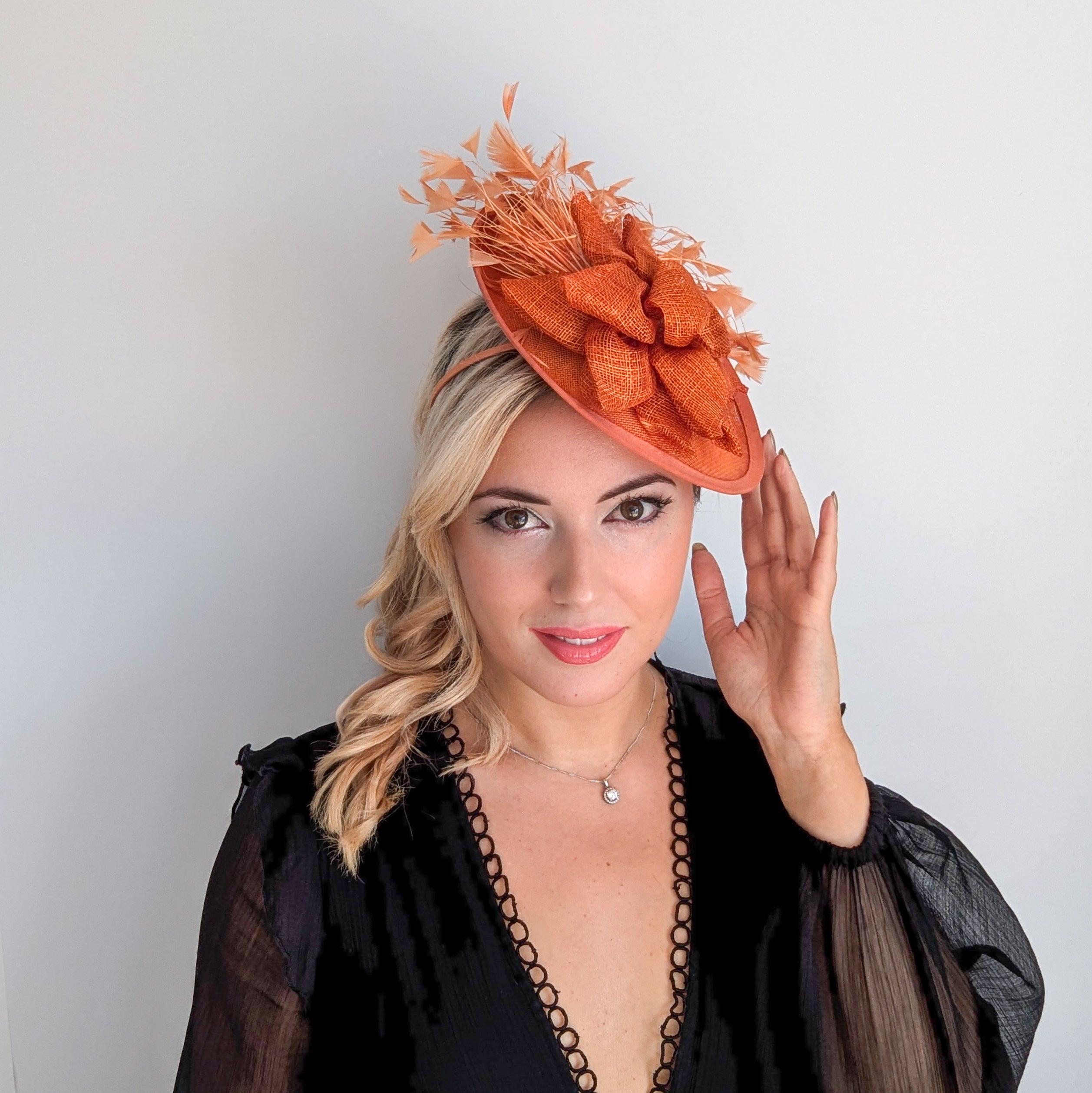 Burnt orange feather disc fascinator hat