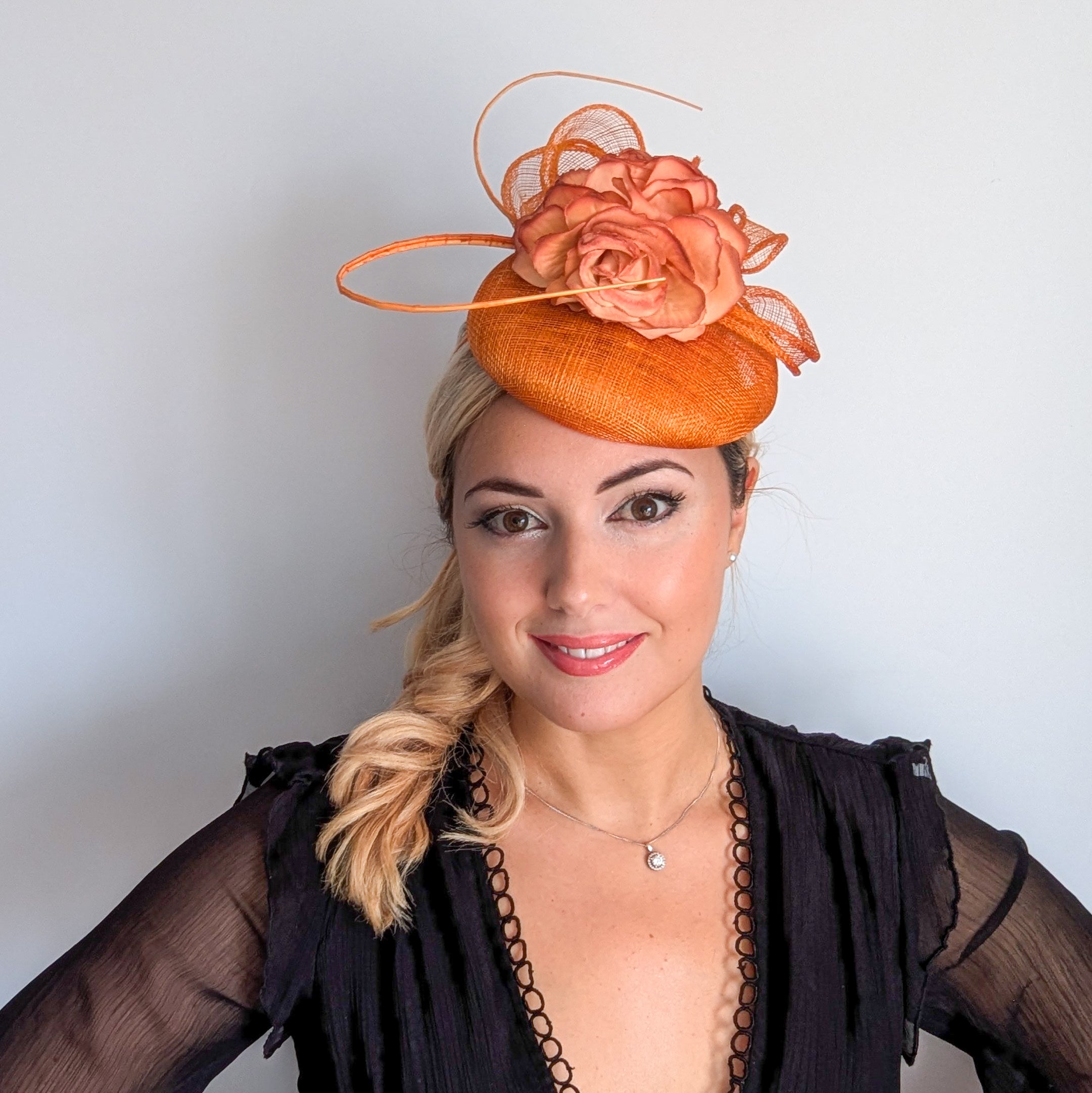 Tangerine orange flower fascinator hat