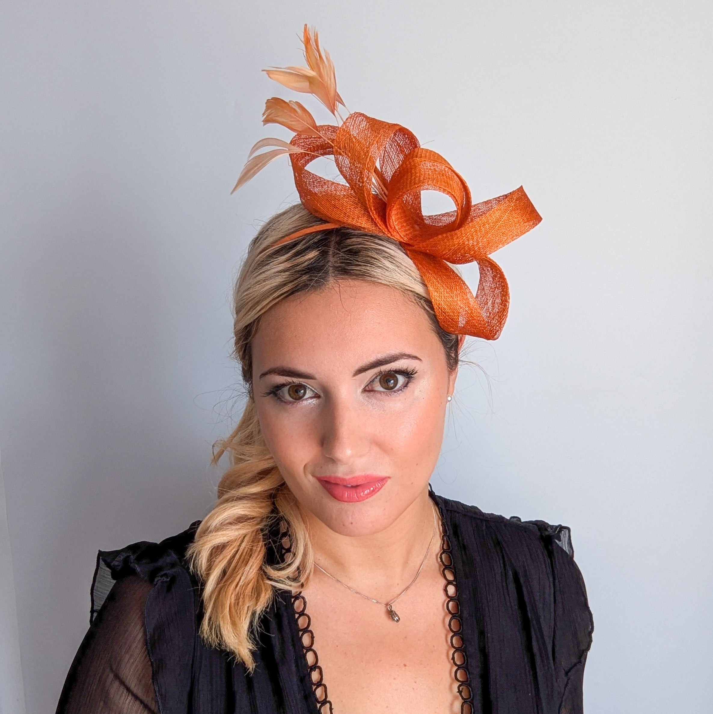 Burnt orange feather fascinator hat