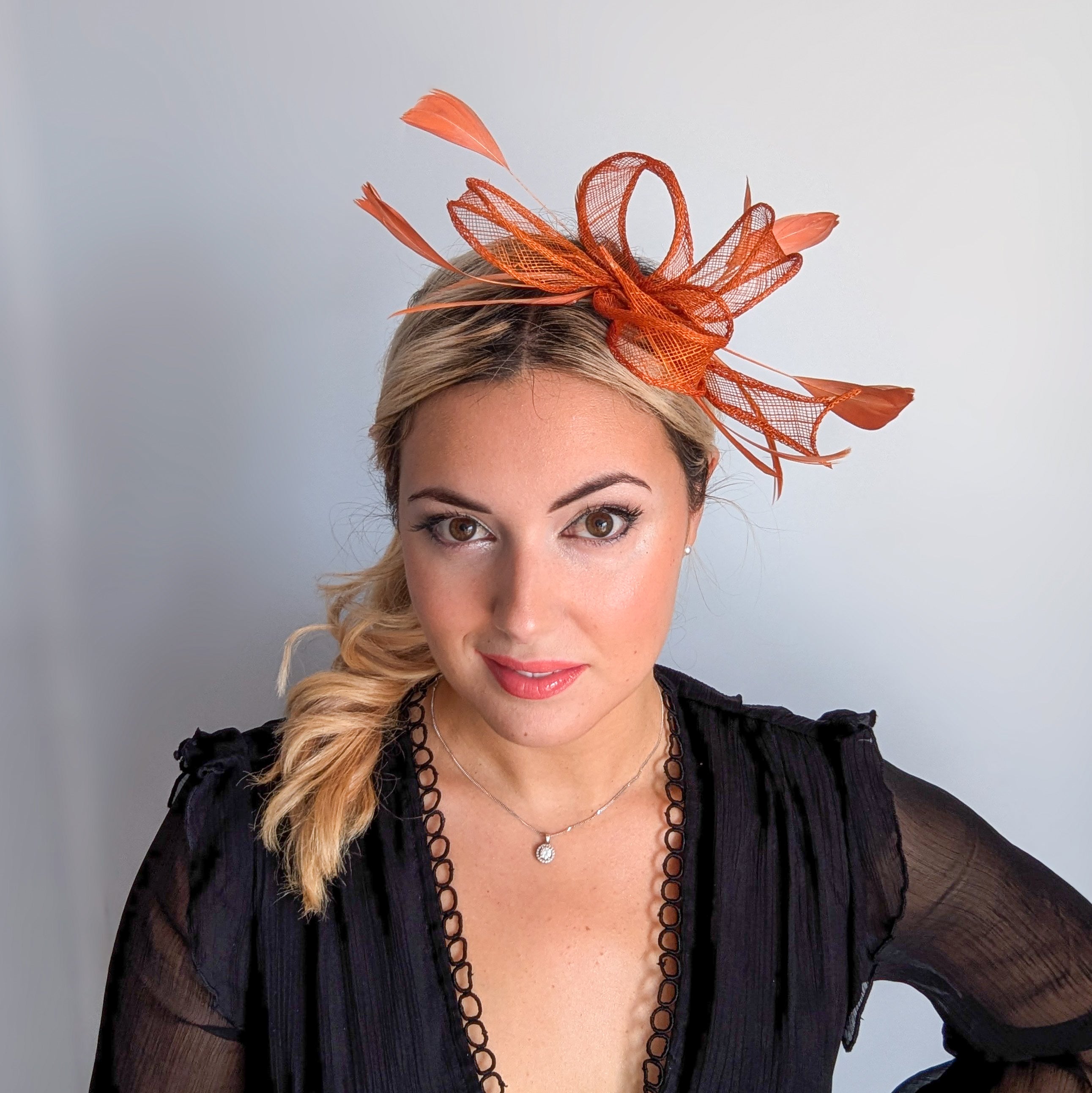 Burnt orange feather fascinator hat