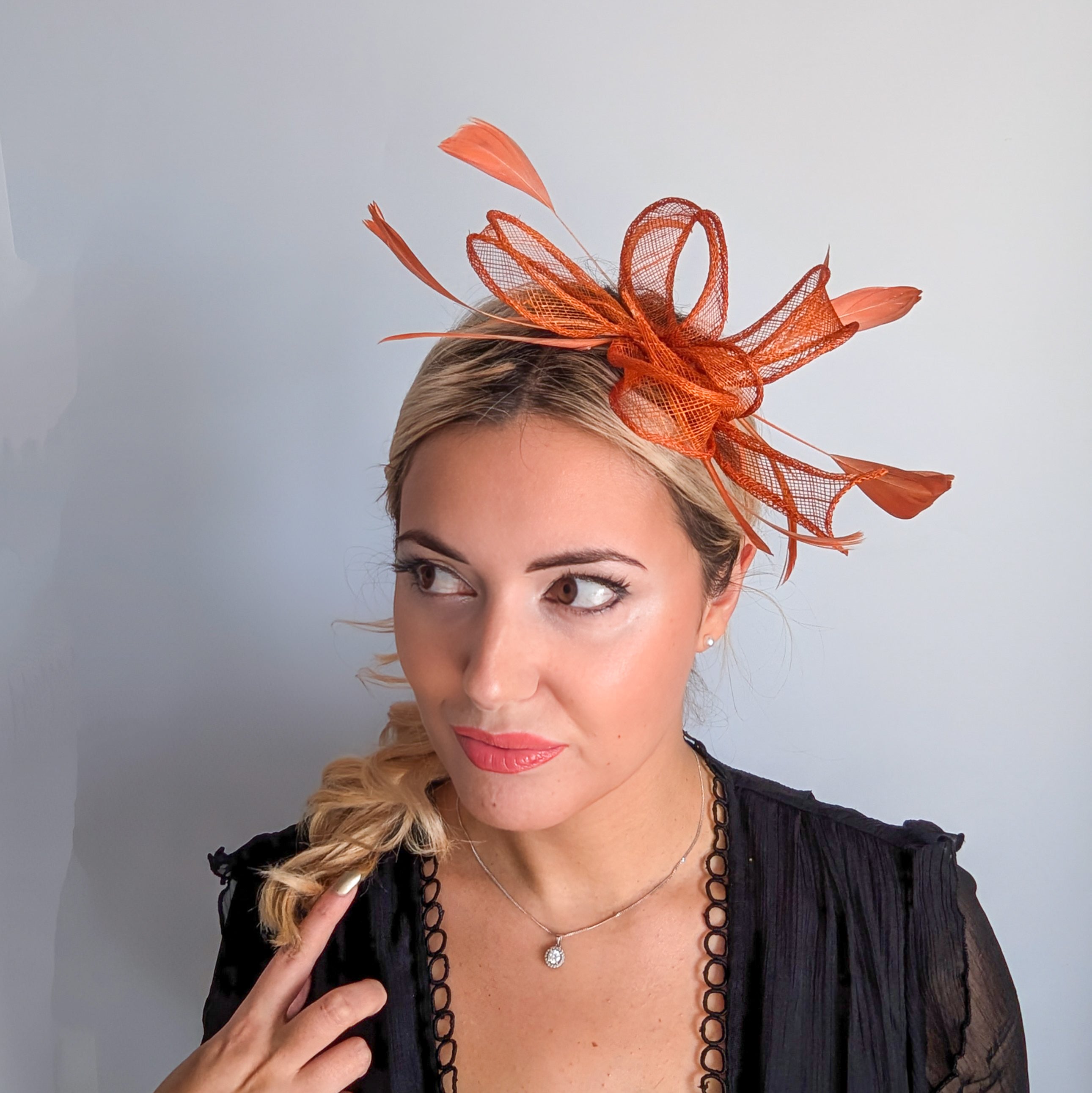 Burnt orange feather fascinator hat