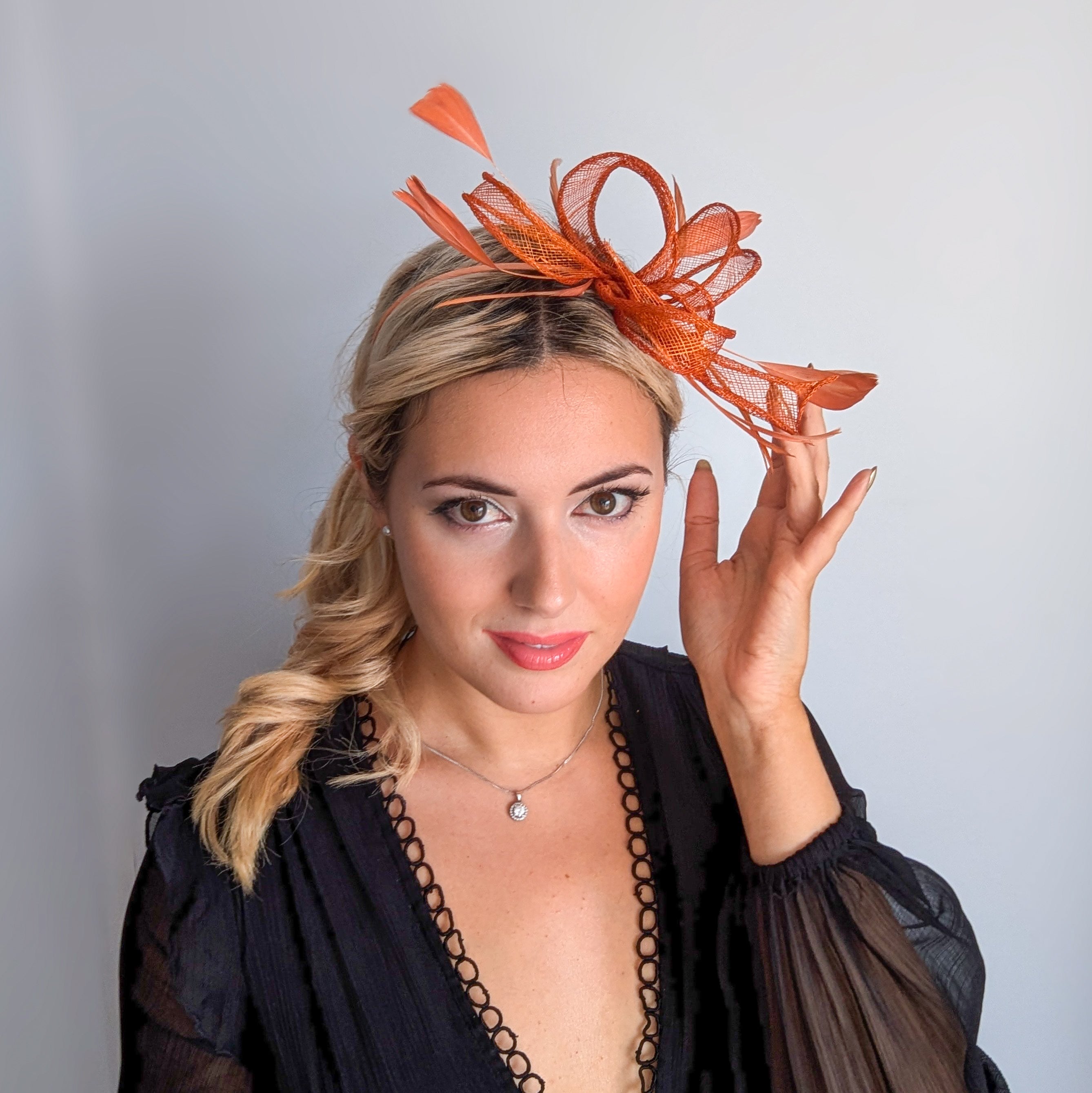 Burnt orange feather fascinator hat
