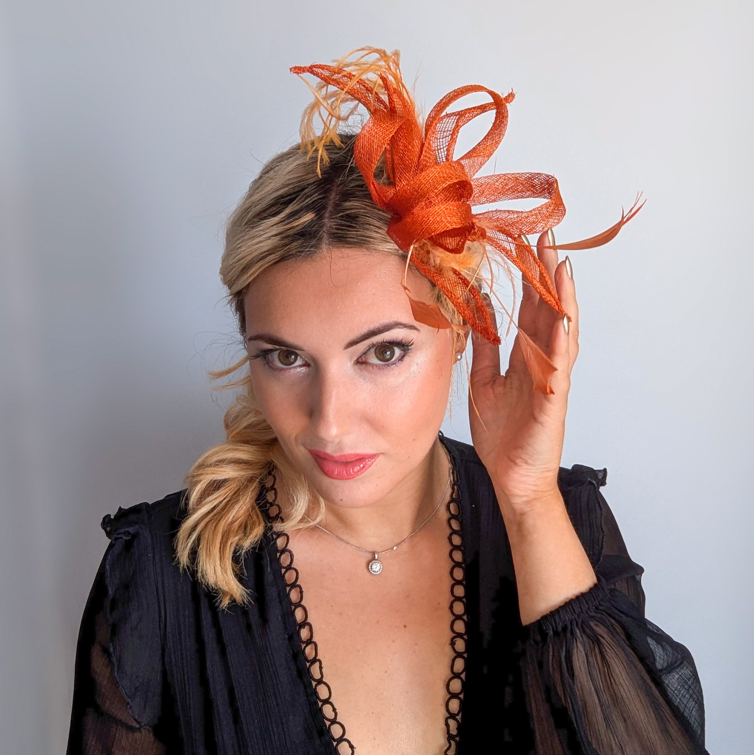 Burnt orange feather fascinator hat