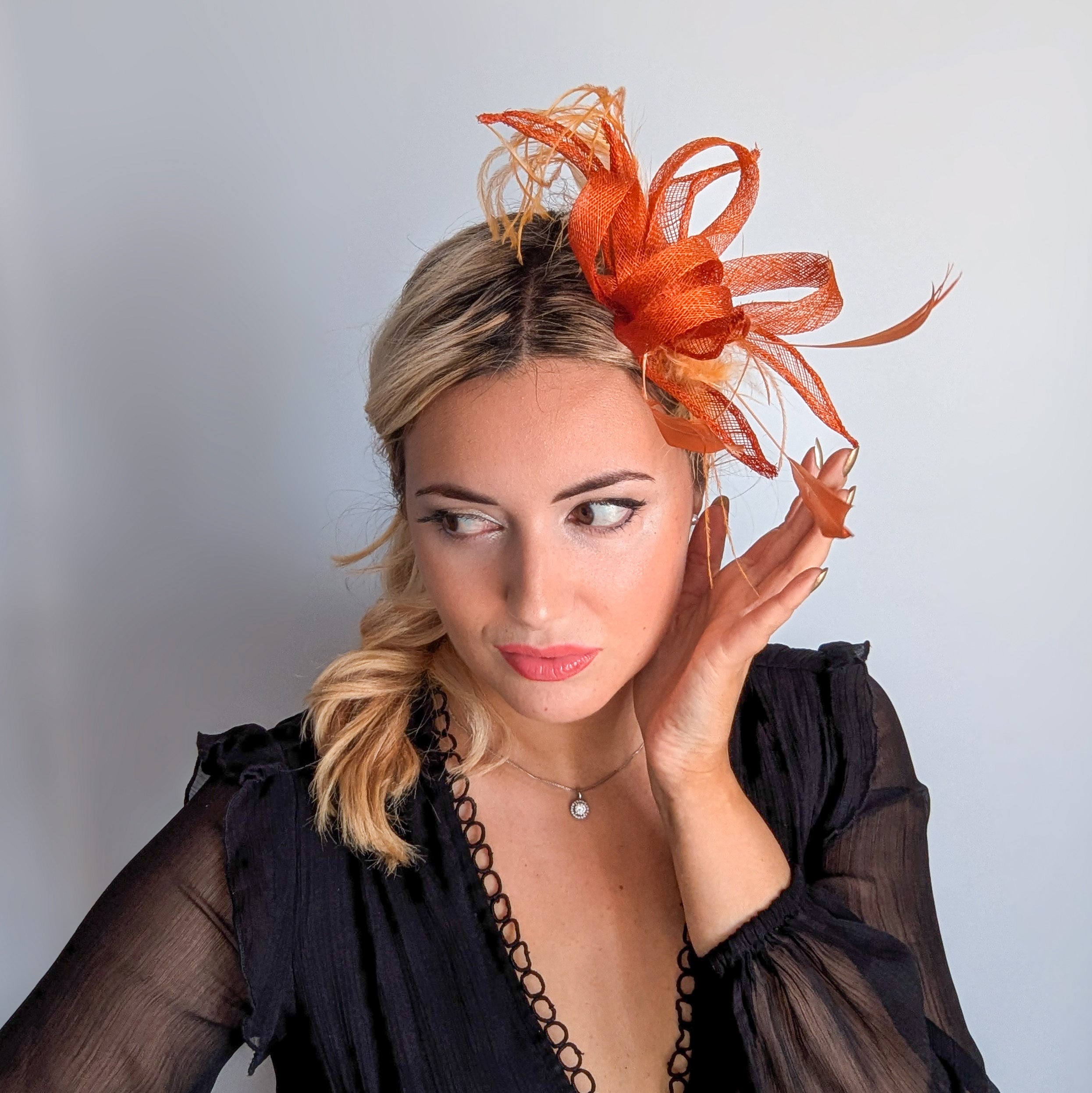 Burnt orange feather fascinator hat