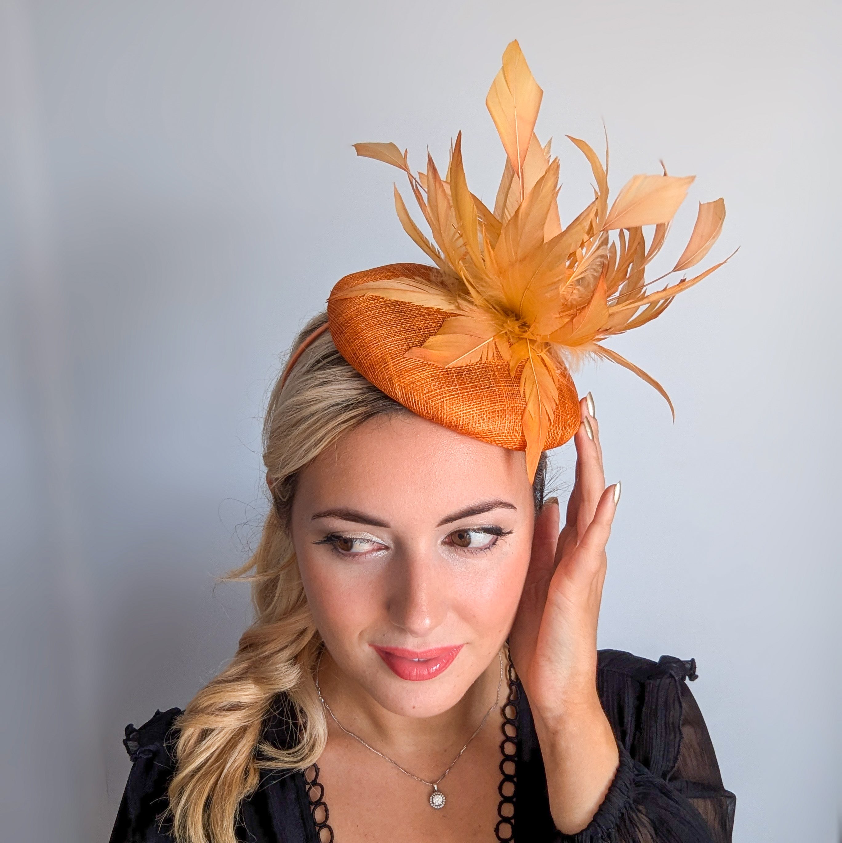 Tangerine orange feather fascinator hat