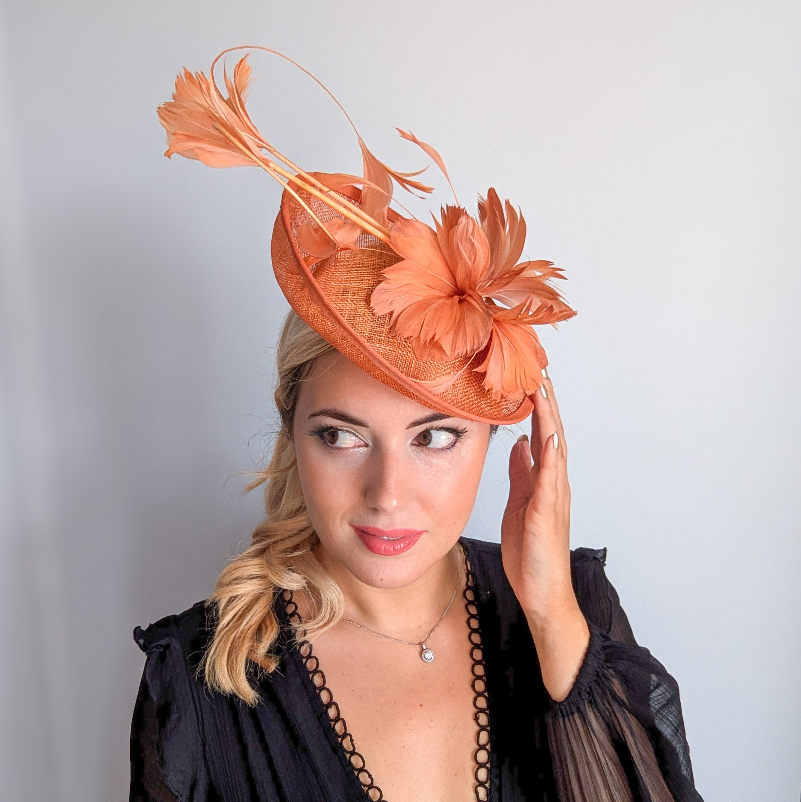 Dusty terracotta orange feather disc fascinator hat