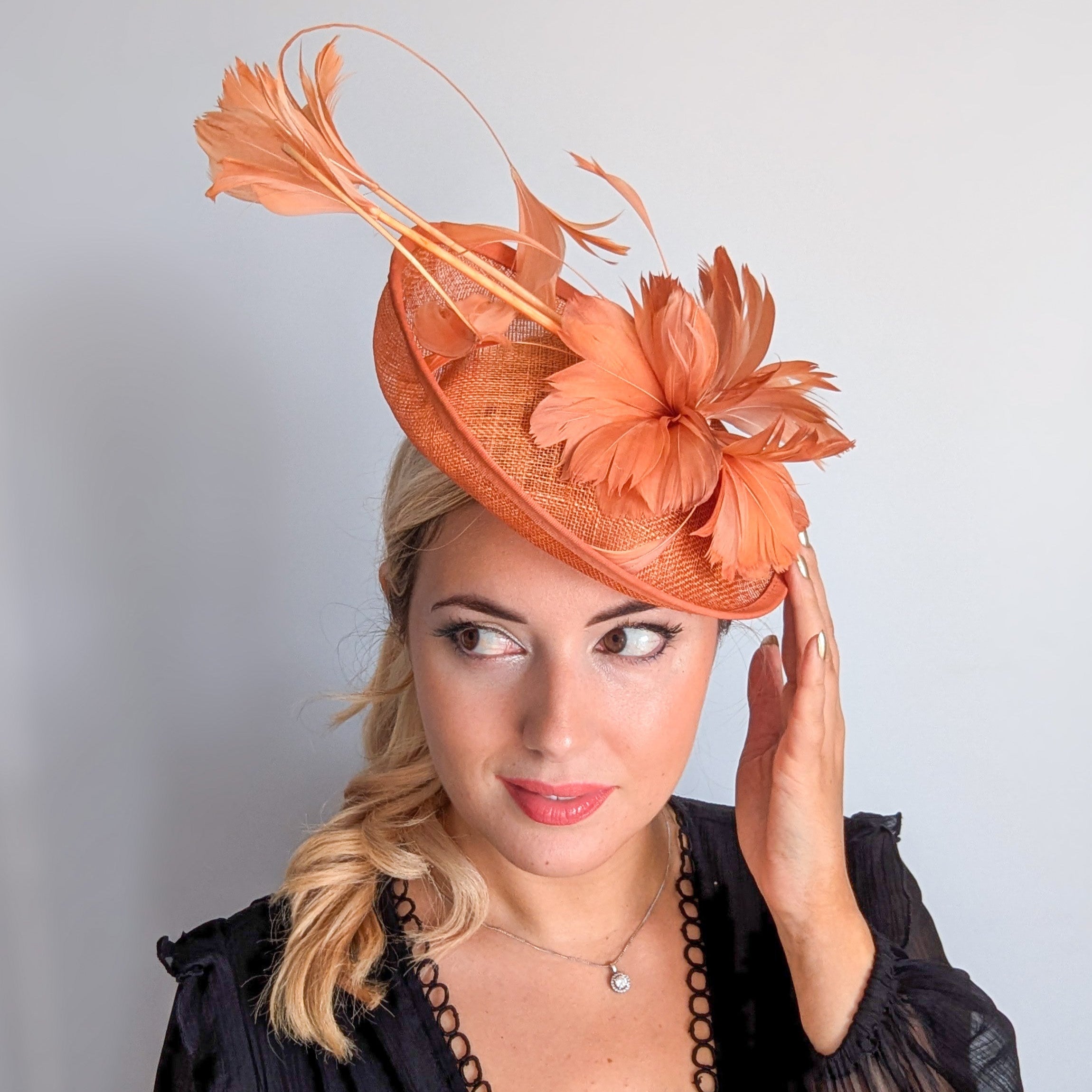 Dusty terracotta orange feather disc fascinator hat