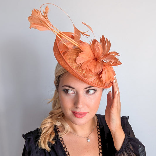 Dusty terracotta orange feather disc fascinator hat