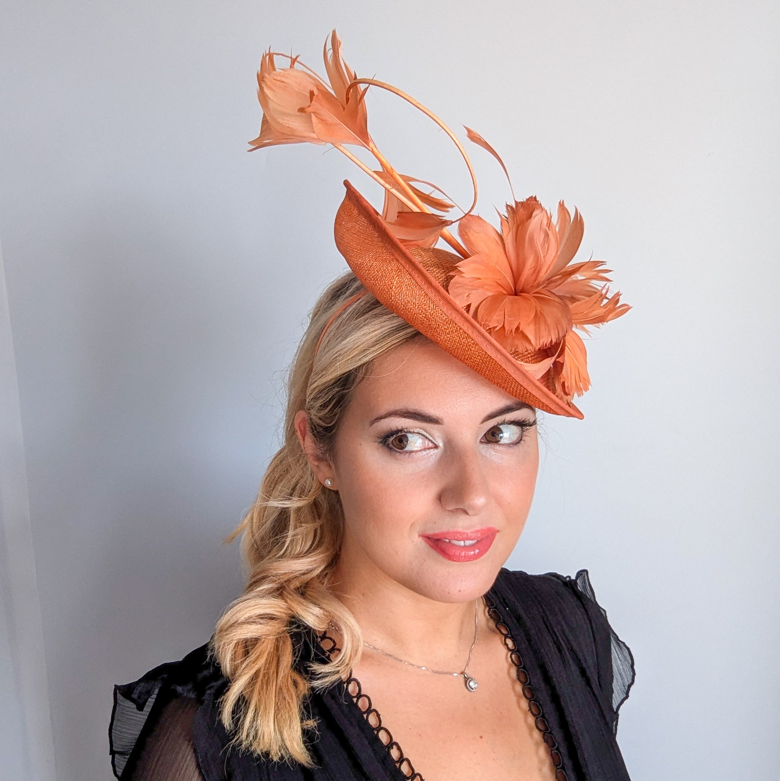 Dusty terracotta orange feather disc fascinator hat