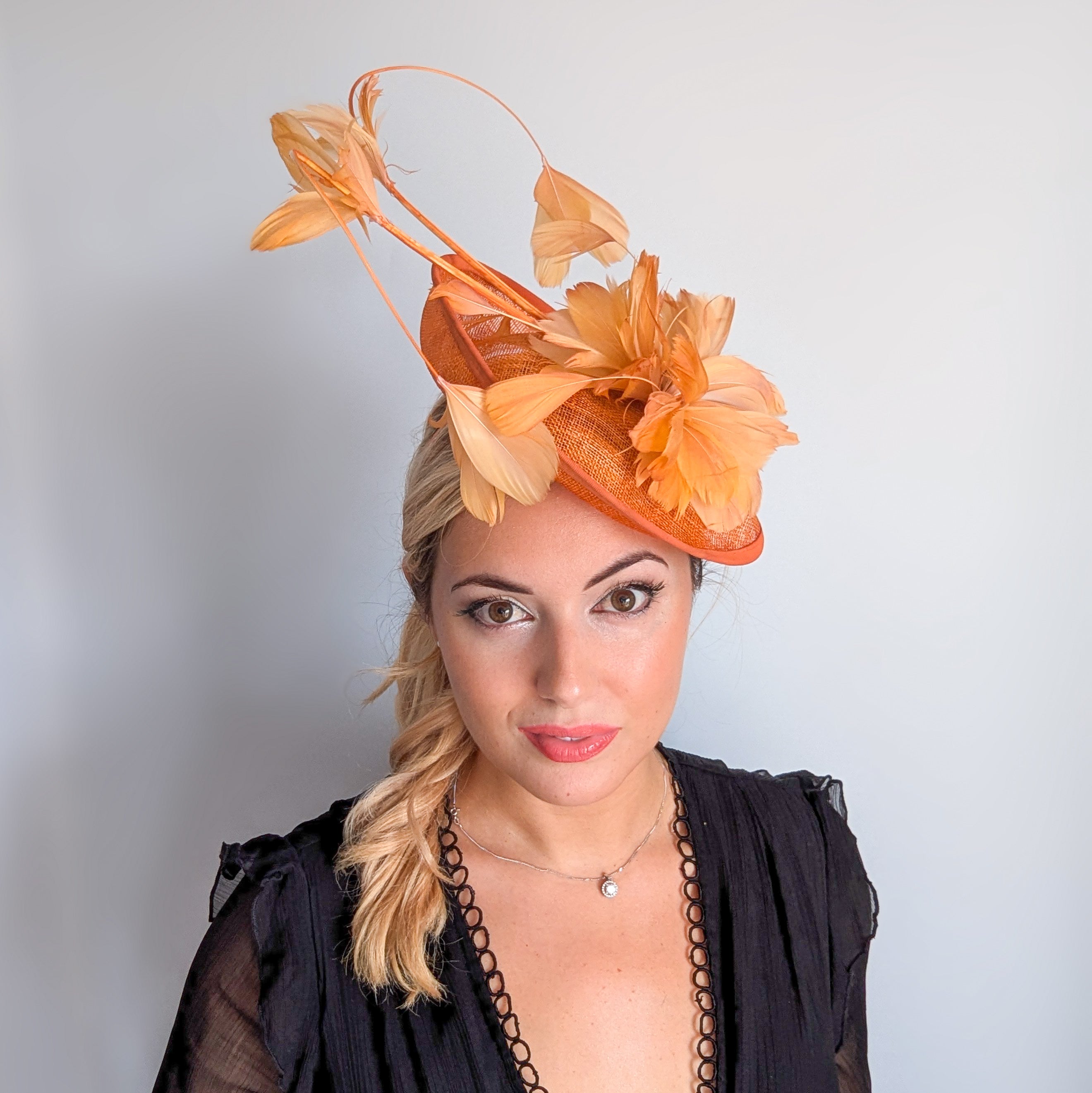 Tangerine orange feather disc fascinator hat