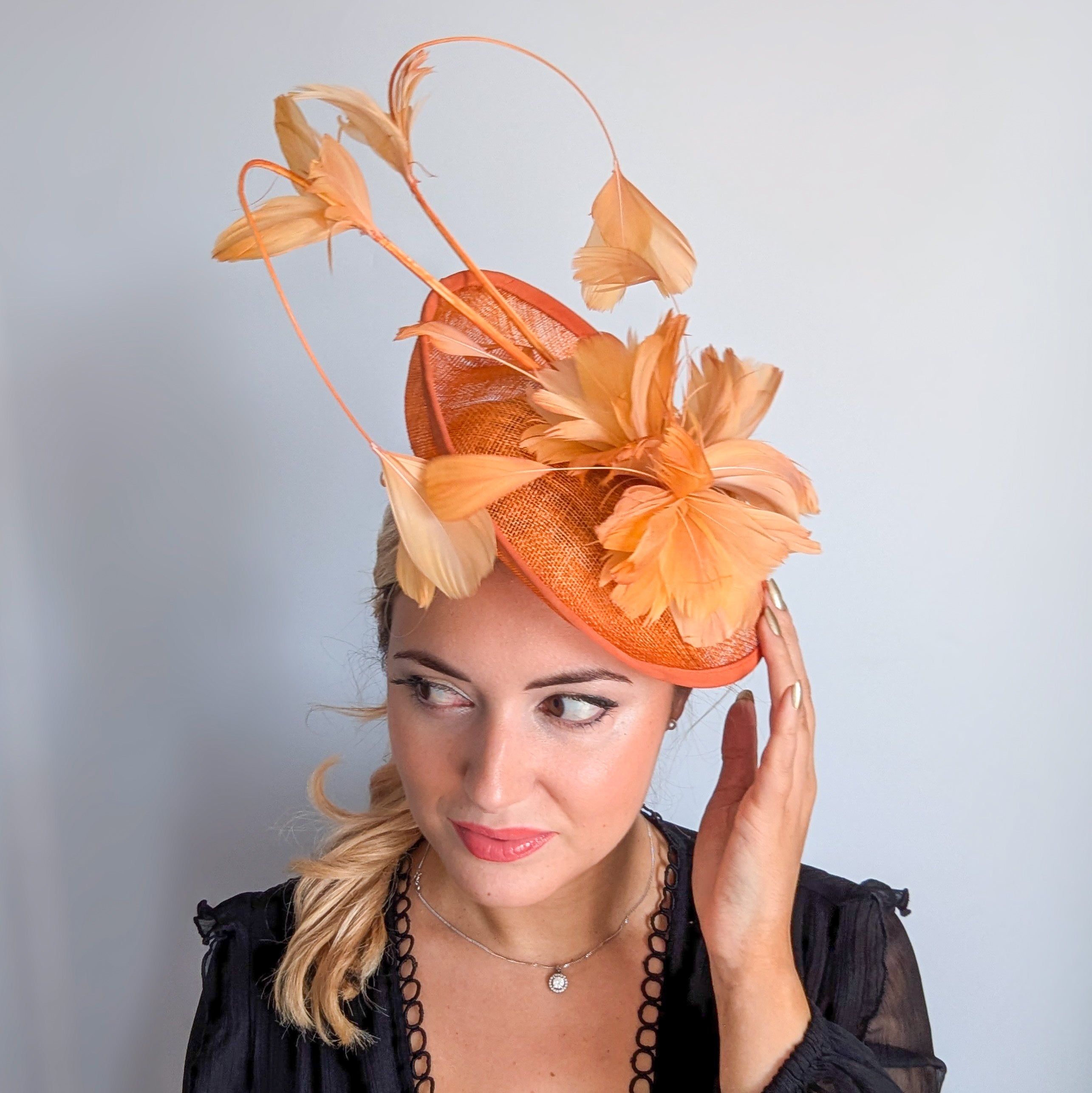 Tangerine orange feather disc fascinator hat