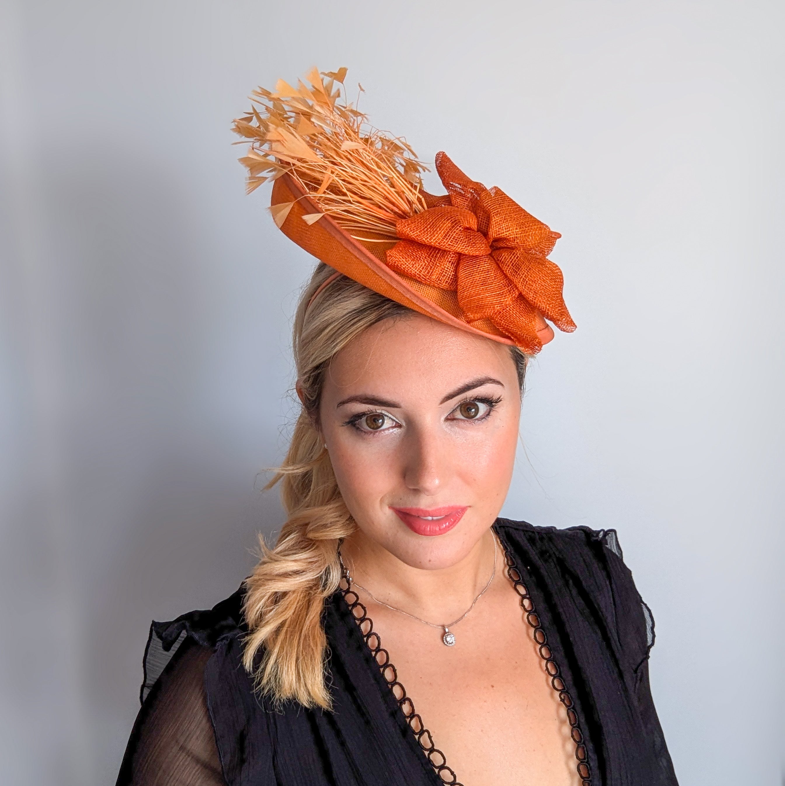 Tangerine orange feather disc fascinator hat