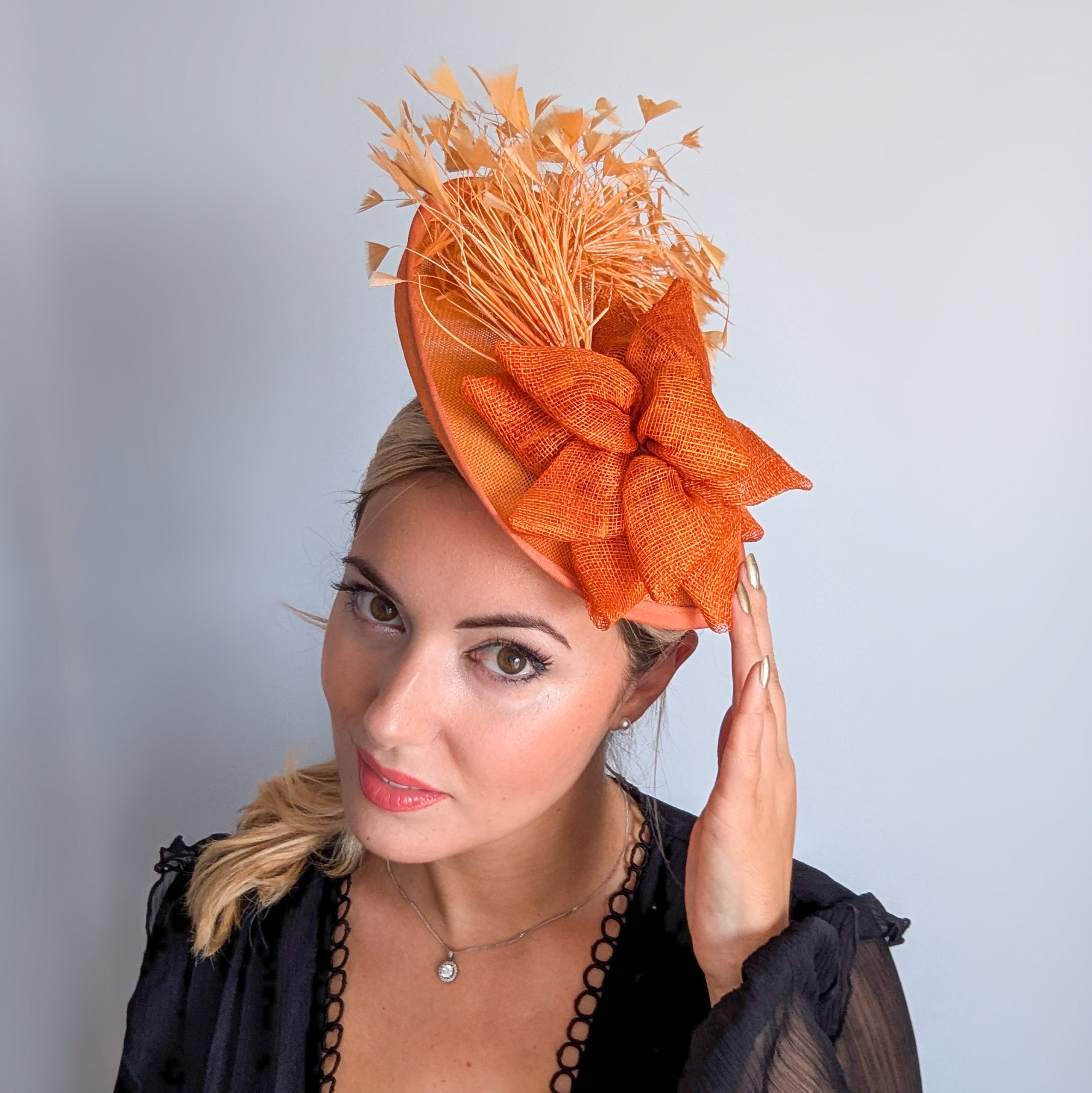 Tangerine orange feather disc fascinator hat