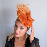 Tangerine orange feather disc fascinator hat