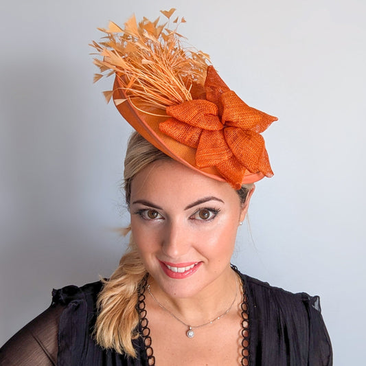 Tangerine orange feather disc fascinator hat