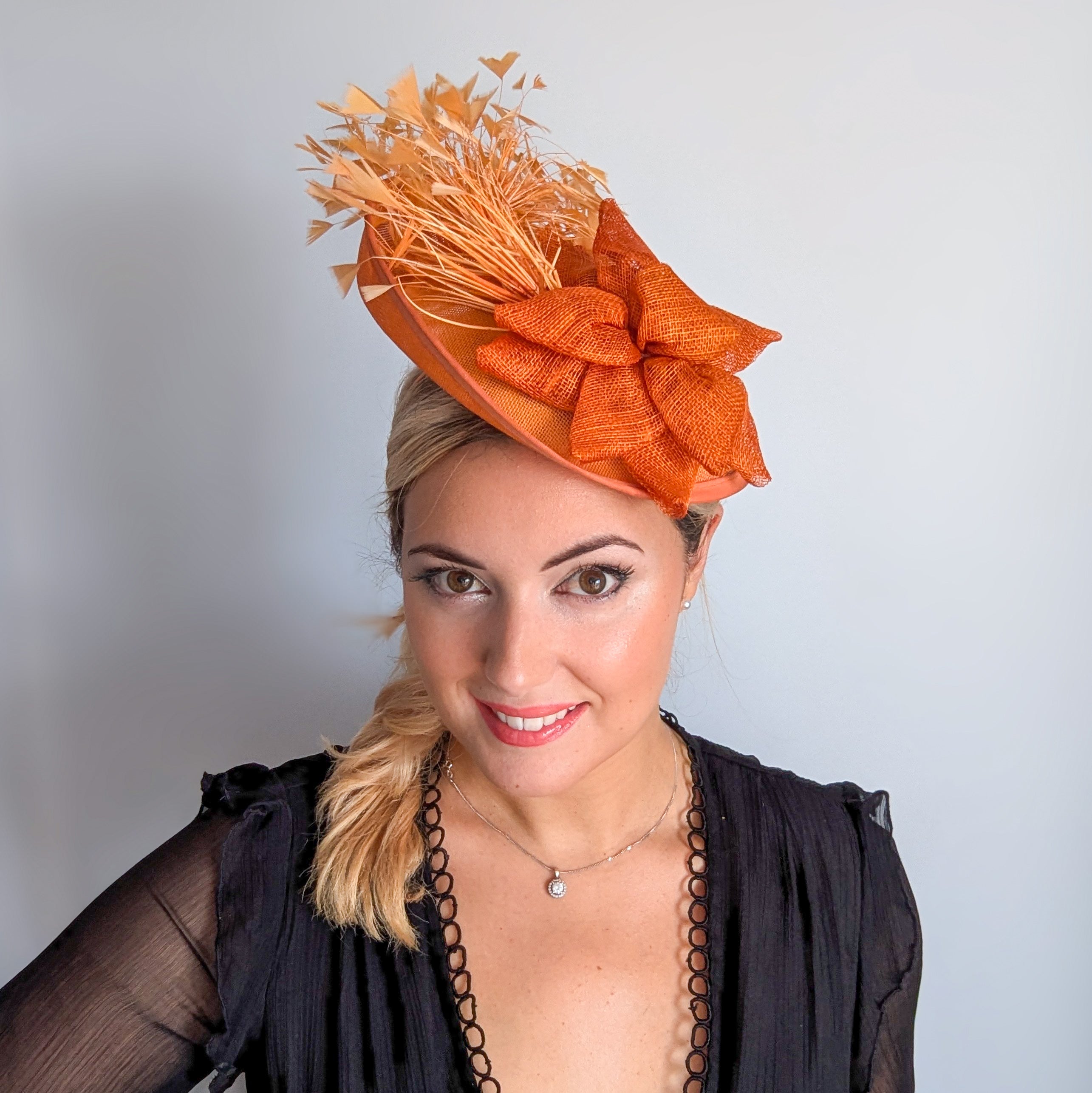 Tangerine orange feather disc fascinator hat
