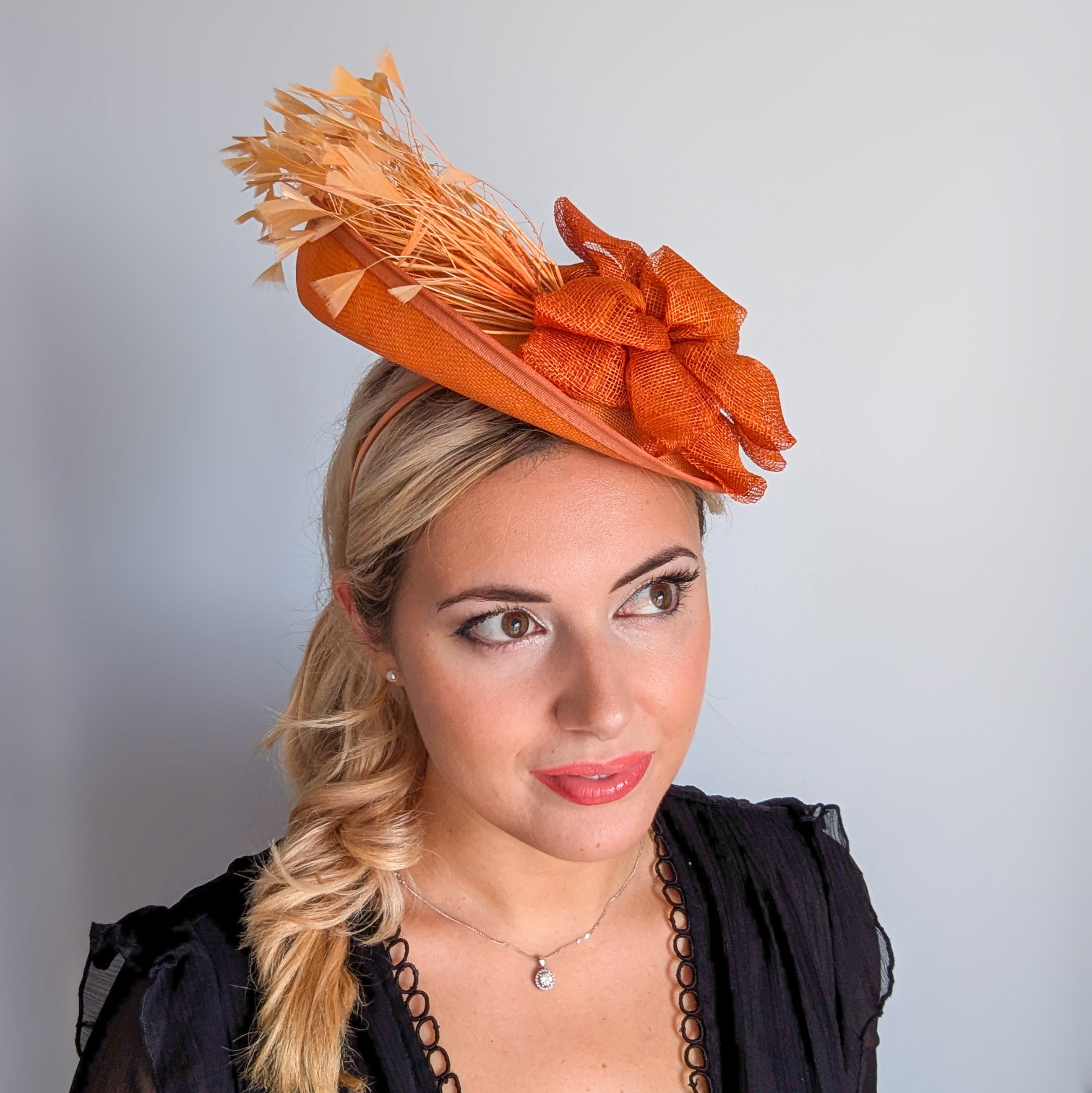 Tangerine orange feather disc fascinator hat