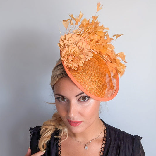 Tangerine orange flower feather disc fascinator hat