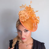 Tangerine orange flower feather disc fascinator hat