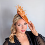 Tangerine orange flower feather disc fascinator hat
