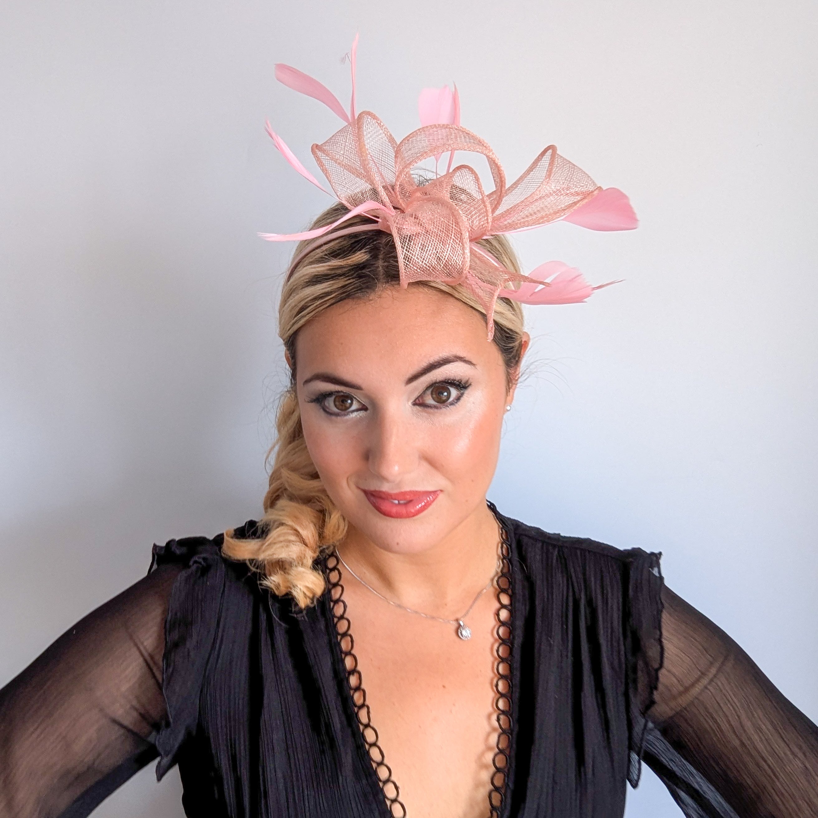 Light peach pink feather fascinator hat