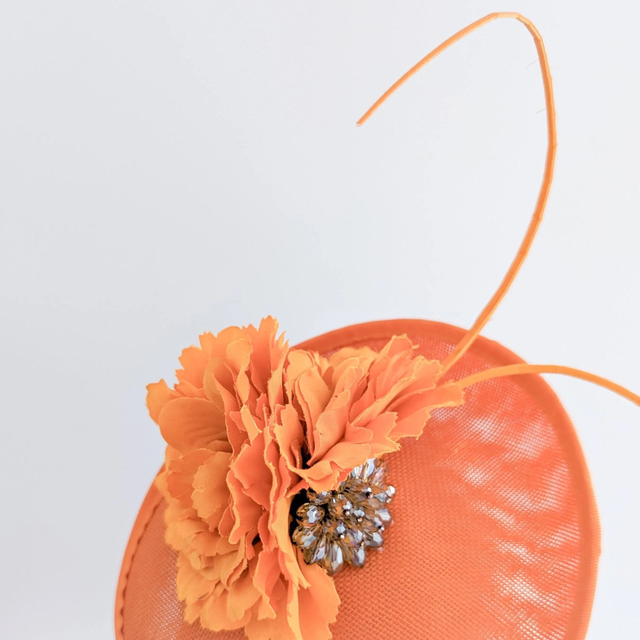 Orange flower disc saucer fascinator hat - House of Hats